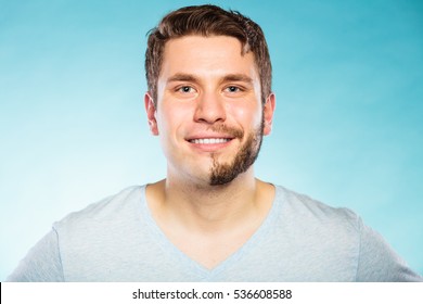 Portrait Of Happy Man With Half Shaved Face Beard Hair. Smiling Handsome Guy On Blue. Skin Care And Hygiene.