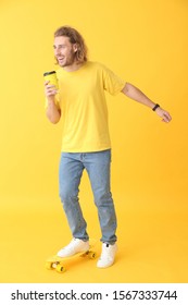 Portrait Of Happy Man With Skateboard And Cup Of Coffee On Color Background