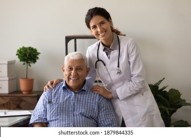 Portrait of happy mature 90s male patient pose in private hospital with female nurse or GP. Smiling young woman doctor take care comfort elderly man client in clinic. Healthcare, geriatrics concept. - Powered by Shutterstock