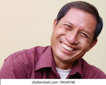 Portrait Of Happy Mature Asian Man Smiling And Looking At Camera. Copy Space