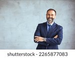 Portrait of happy mature businessman looking at camera. Multiethnic satisfied man with beard feeling confident at office. Successful middle eastern business man smiling in a creative office