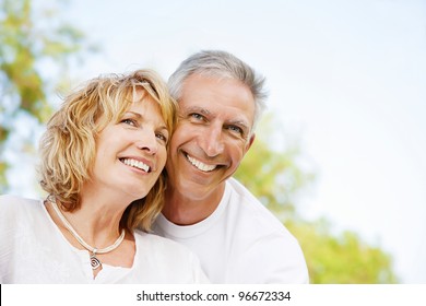 Portrait of a happy mature couple outdoors. Shallow DoF with focus on woman.