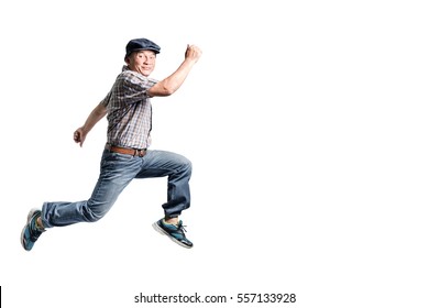 Portrait of a happy mature man jumping forward. Isolated full body on white background - Shutterstock ID 557133928