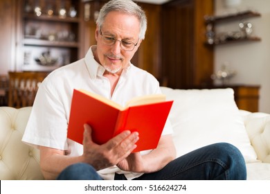 Portrait Of An Happy Mature Man Reading A Book