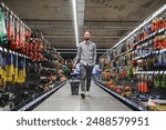 Portrait of happy mature man standing in hardware store.