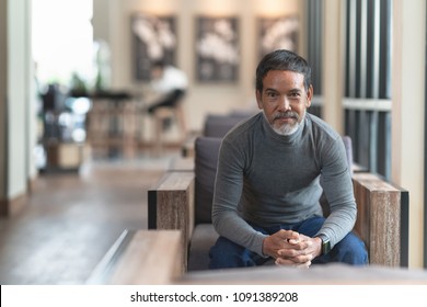 Portrait Of Happy Mature Man With White Stylish Short Beard Looking At Camera. Casual Lifestyle Of Retired Hispanic People Or Adult Asian Man Smile With Confident Sitting At Modern Coffee Shop Cafe.