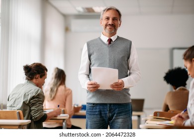 Portrait of happy mature professor during lecture in the classroom looking at camera.  - Shutterstock ID 2064472328