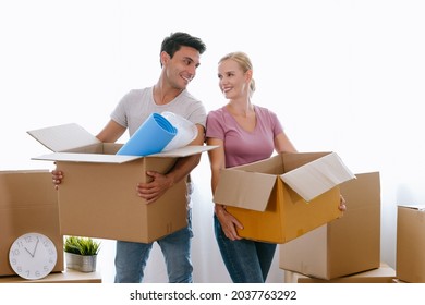 Portrait Of Happy Middle Age Couple Moving To A New House, Holding Cardboard Boxing Smiling Happy In Love With Apartment. Relocation, Renovation, Home And Family Concept