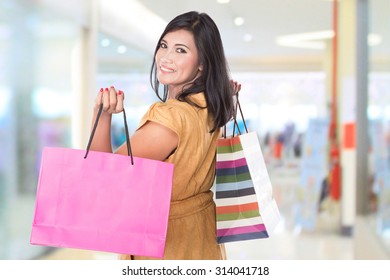 A Portrait Of Happy Middle Aged Asian Woman Holding Shopping Bags