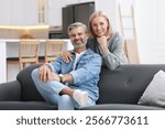 Portrait of happy middle aged couple in kitchen