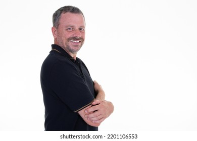 Portrait Of Happy Middle Aged Man Side Profile Standing Arms Folded White Wall Background Wearing Casual Shirt Black Copy Space