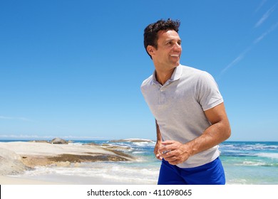 Portrait Of A Happy Middle Aged Man Walking On The Beach