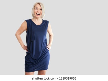 Portrait of happy middle aged woman smiling isolated on grey background.