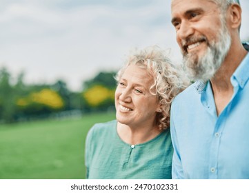 Portrait of a happy middle aged woman and  active middle aged white couple having fun walking holding hands and bonding in park outdoors - Powered by Shutterstock