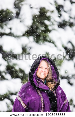 A portrait of a happy middle aged woman in a snowy Colorado, USA