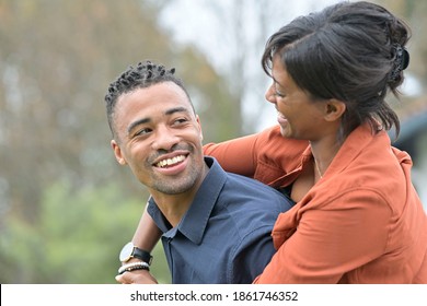 Portrait Of Happy Mixed Raced Couple Standing Outside The House