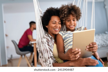 Portrait of happy mother with child using digital tablet for education, fun, game. Technology people - Powered by Shutterstock