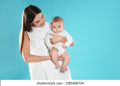 Portrait Of Happy Mother With Her Baby On Color Background. Space For Text