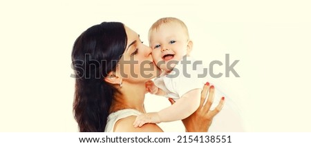 Portrait of happy mother holding and kissing her cute baby on white background, blank copy space for advertising text