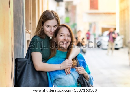 Similar – Image, Stock Photo Twin sisters look around in an alleyway