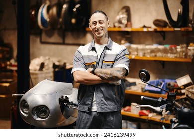 Portrait of happy motorcycle mechanic standing in his workshop - Powered by Shutterstock