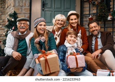 Portrait of happy multigeneration family in front of the house while gathering for Thanksgiving and looking at camera.  - Powered by Shutterstock