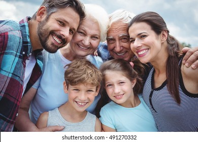 Portrait of happy multi-generation family standing outdoors - Powered by Shutterstock