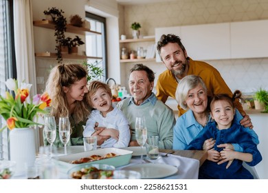 Portrait of happy multigenerational family during Easter dinner. - Powered by Shutterstock