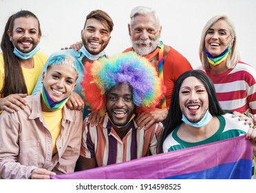 Portrait Of Happy Multriacial Gay People At Pride Parade Wearing Protective Face Mask Under Chin - Alternative Lgbt Event For Coronavirus Outbreak