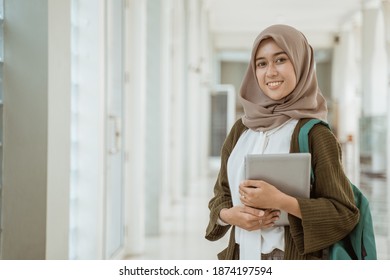 Portrait happy muslim female student looking at the camera on the campus. - Powered by Shutterstock