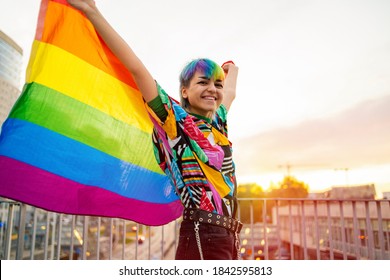 Portrait of happy non-binary person waving rainbow flag
 - Powered by Shutterstock