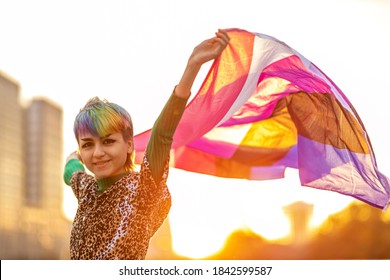 Portrait of happy non-binary person waving gender fluid flag
 - Powered by Shutterstock