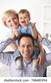 Portrait Of Happy Nuclear Family Having Fun Together At Home.