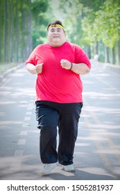 Portrait of happy obese man wearing sportswear while doing run exercises in the park