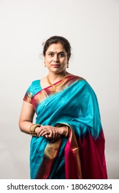 Portrait of Happy Old indian woman or lady in ethnic saree with jewelry or jewellery, isolated over white background