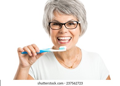 Portrait Of A Happy Old Woman Brushing Her Teeth