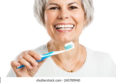 Portrait Of A Happy Old Woman Brushing Her Teeth