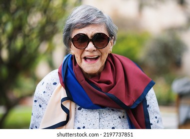 Portrait Of Happy Old Woman Laughing Wearing Sunglasses