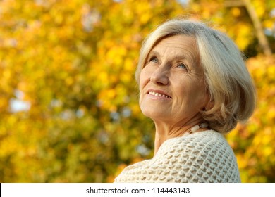 Portrait Of A Happy Old Woman Posing At Nature