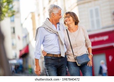 Portrait Happy Older Couple Walking On Street And Looking At Each Other Face