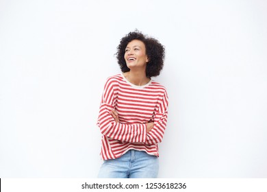 Portrait of happy older woman laughing with arms crossed against white background