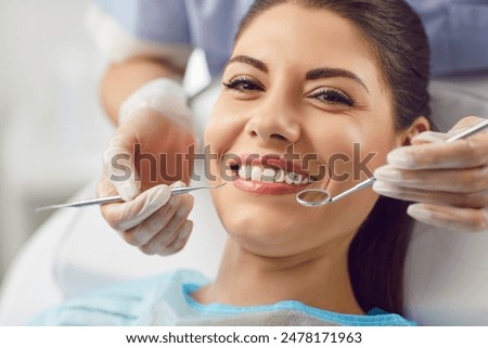 Similar – Image, Stock Photo Dentist and patient at modern medical center. Doctor treats a young woman teeth in hospital. Practitioner examines the patient before orthodontists or prosthetics treatment.