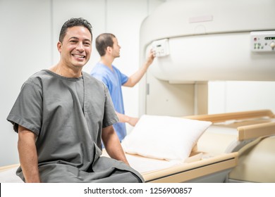 Portrait Of Happy Patient Looking At Camera Before MRI In Hospital Lab. Middle Aged Man Smiling In Clinic Before Medical Treatment. Latino People And Health Care. Copyspace Included