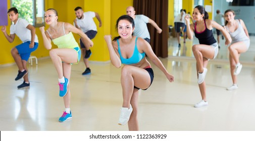 Portrait Of Happy People Dancing Zumba In Dance Class