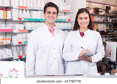 Portrait Of Happy Pharmacist And Pharmacy Technician In Drugstore