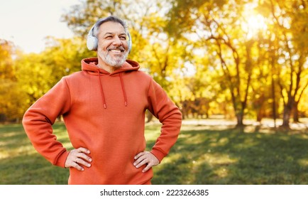 Portrait of happy positive mature man with broad smile  in headphones while doing sport in city park, active retired male sportsman jogging outside in early morning. Healthy lifestyle concept - Powered by Shutterstock