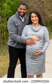 Portrait Of A Happy Pregnant Couple Outside.