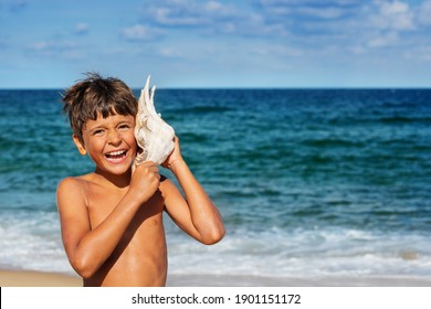 Portrait Of A Happy Relaxed Boy Listen To Huge Seashell With Big Smile Over Sea Background