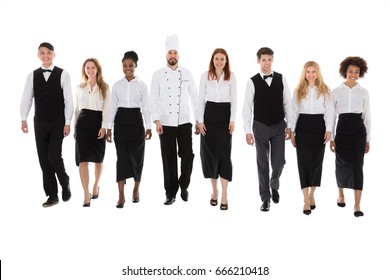 Portrait Of Happy Restaurant Staff Walking Against White Background