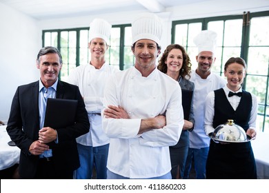 Portrait Of Happy Restaurant Team Standing Together In Restaurant